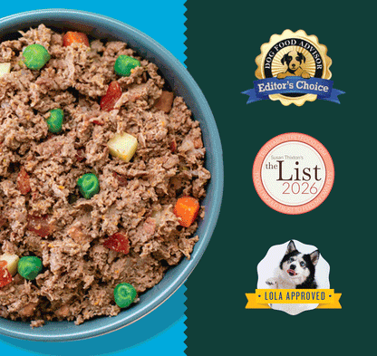 Blue bowl filled with ground meat mixture and green peas, red and orange vegetable pieces.