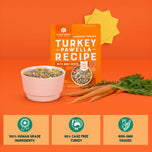 Turkey Pawella Recipe dog food package with bowl of prepared meal, carrots, and fresh greens on orange background.